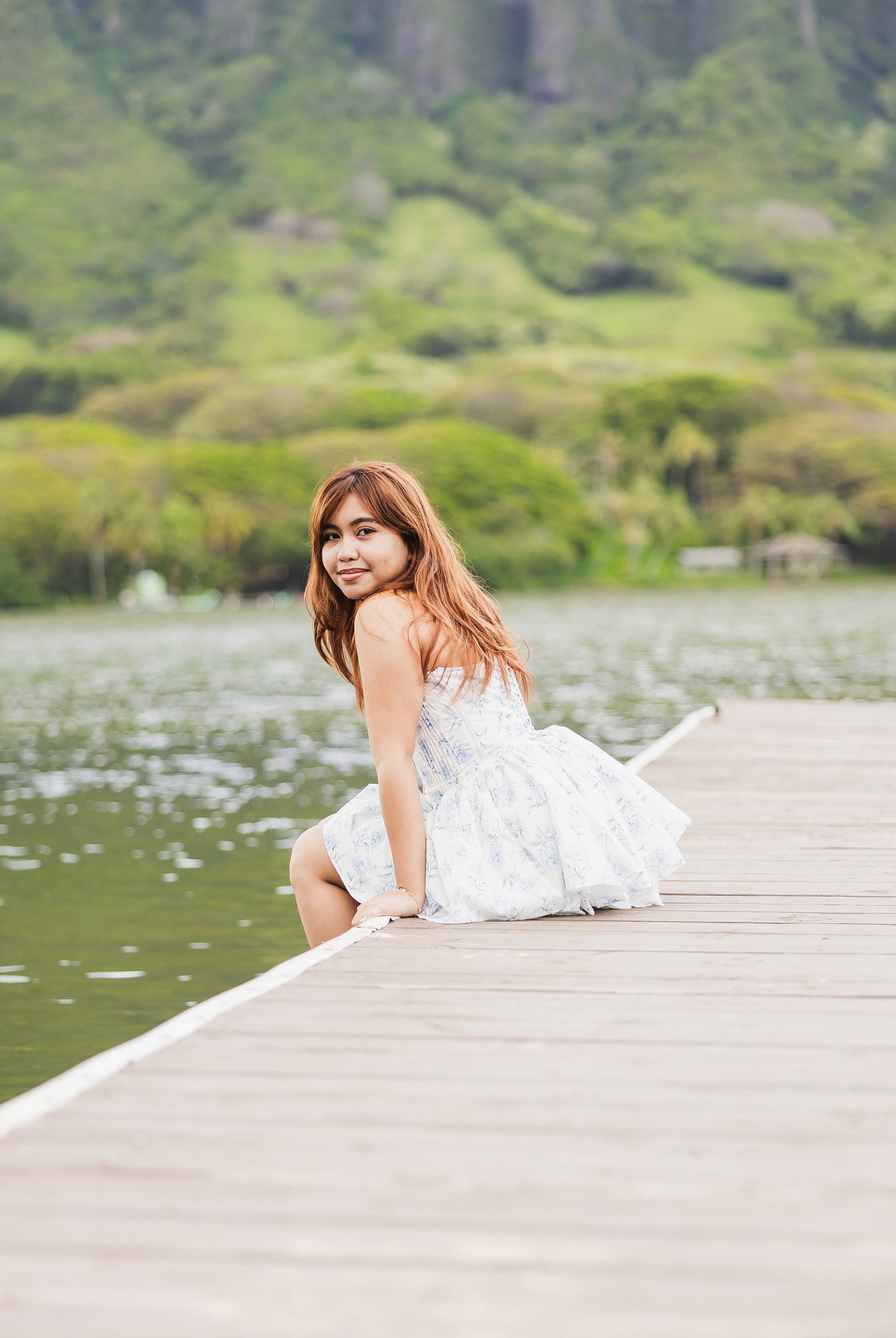 Graduation portrait at scenic waterfront dock on Oahu Hawaii