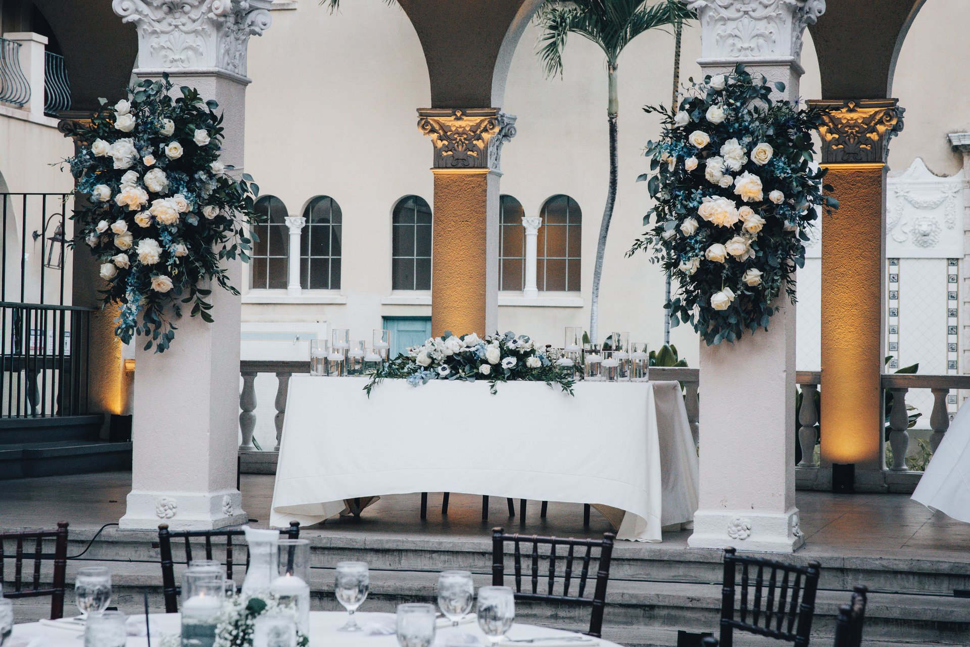 Elegant sweetheart table with large blue and white floral arrangements at Honolulu wedding reception